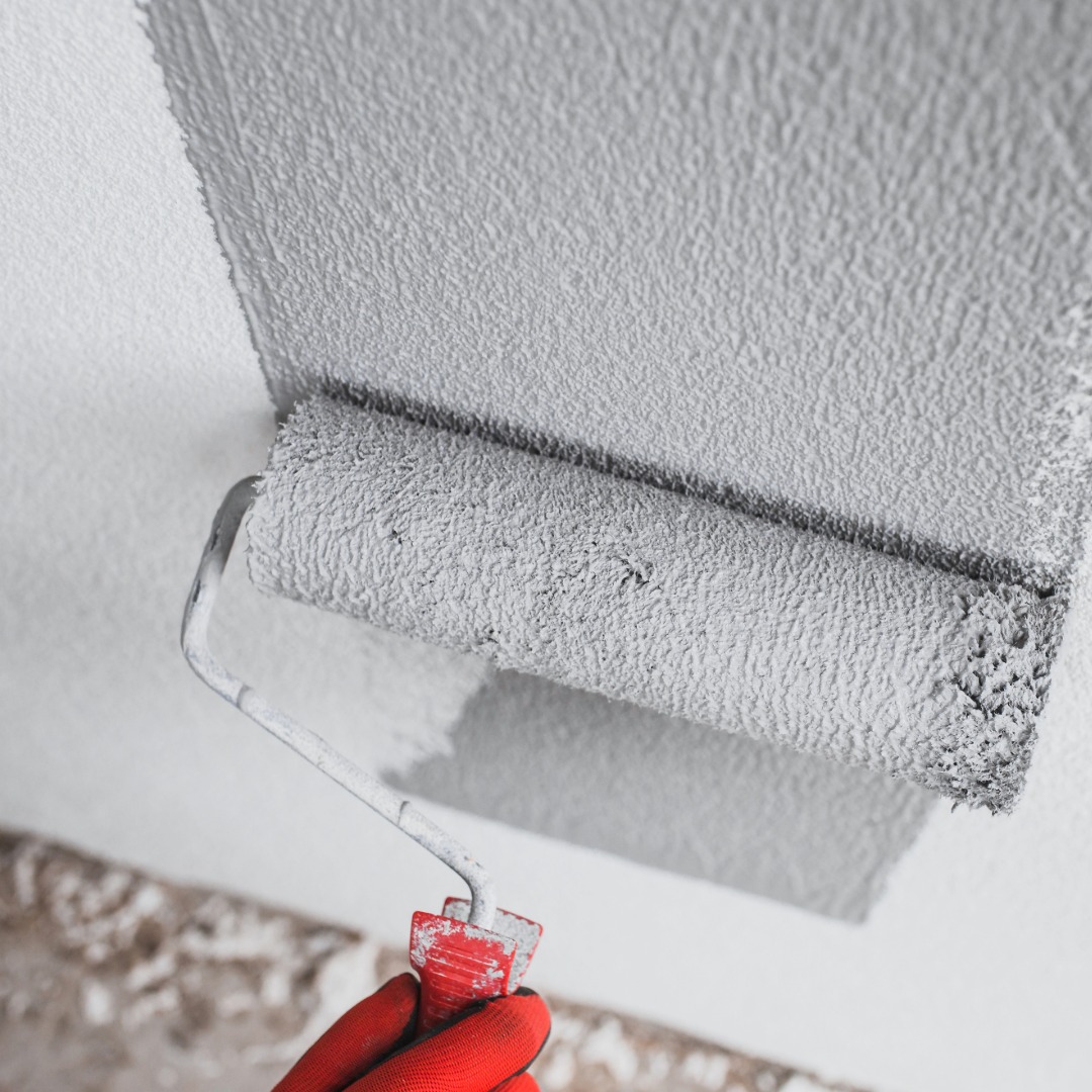 Paint roller applying paint to a residential wall